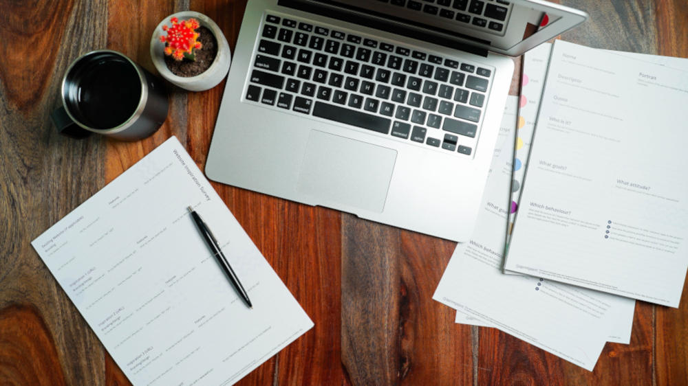 computer and paperwork on a desk