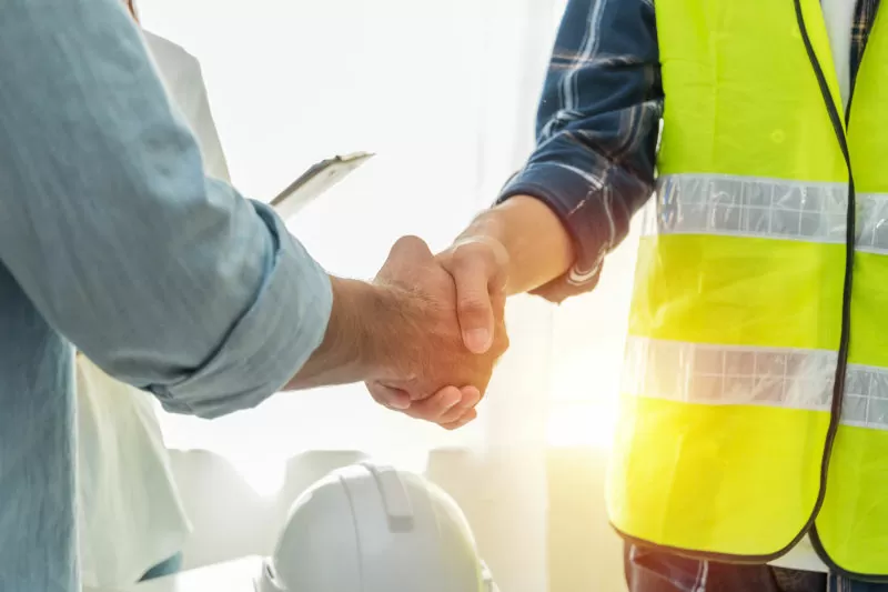 Contractor. construction worker team hands shaking after plan project